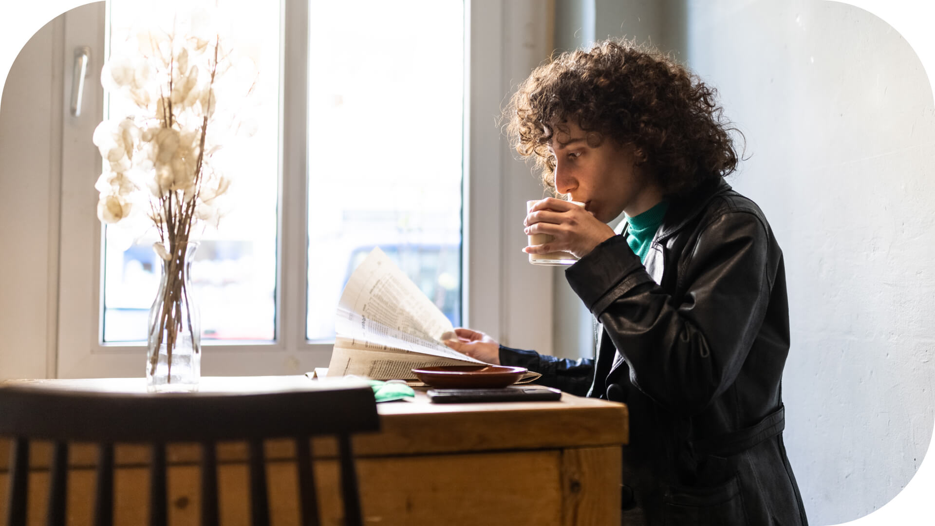 socially responsible investments - person sipping a beverage and reading papers