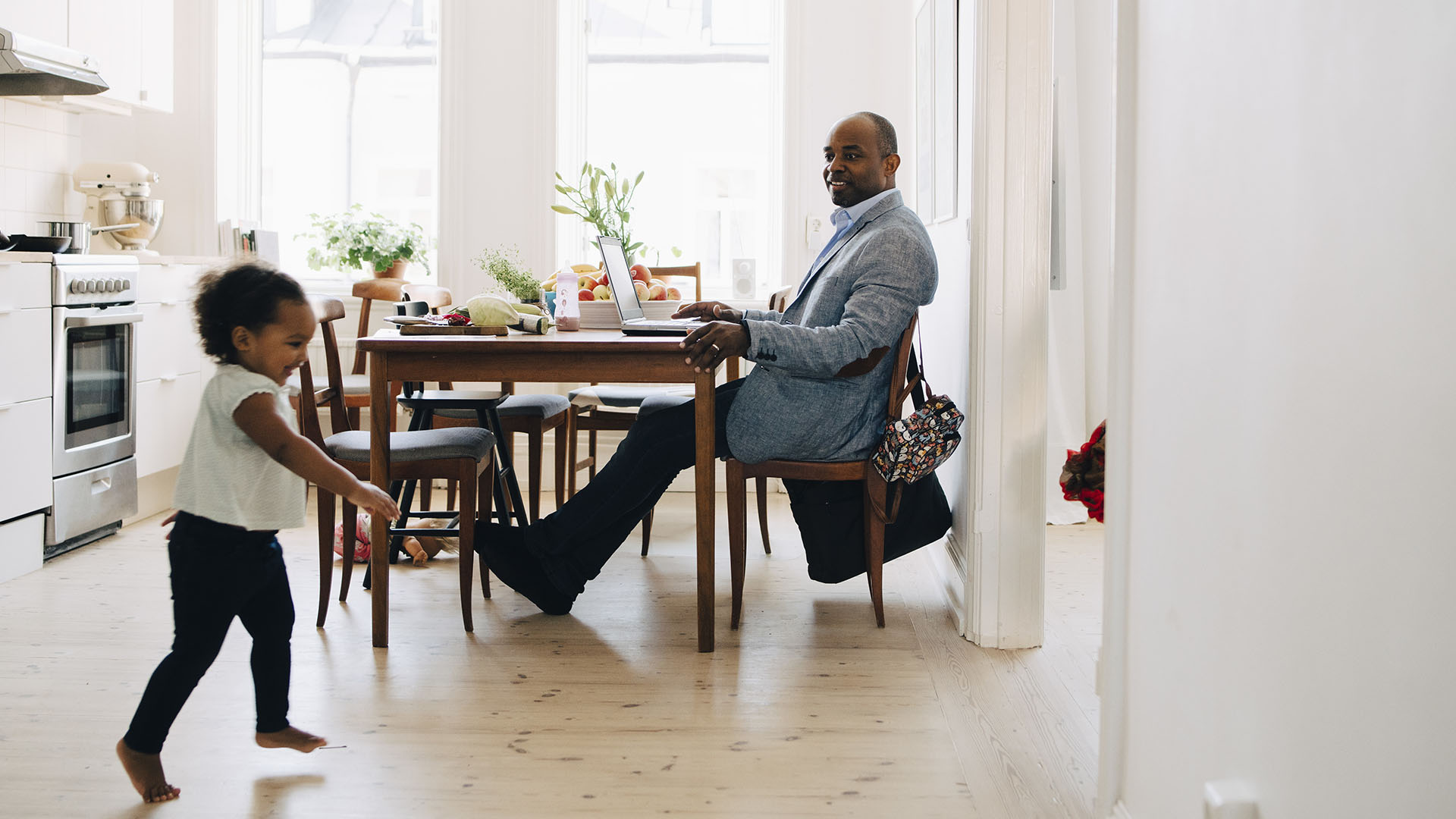 smiling parent on leave of absence with happy child in frame