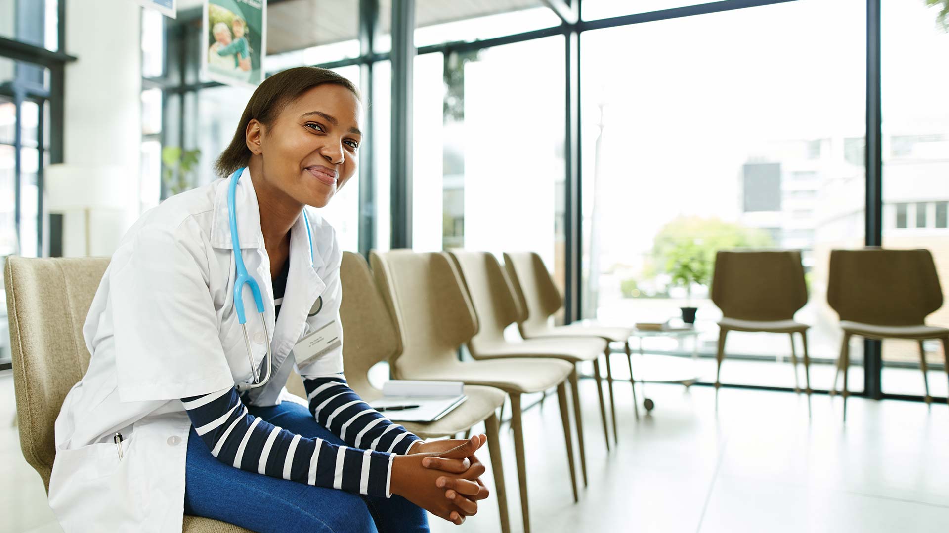 smiling doctor sitting in hospital