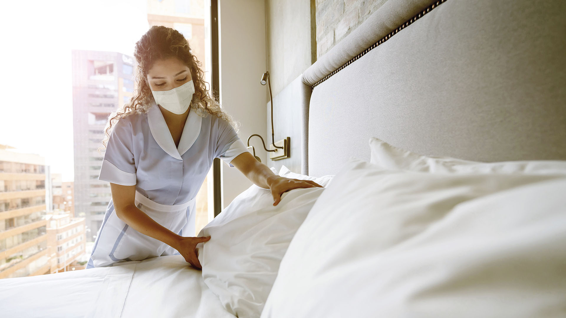 nurse making bed in hospital