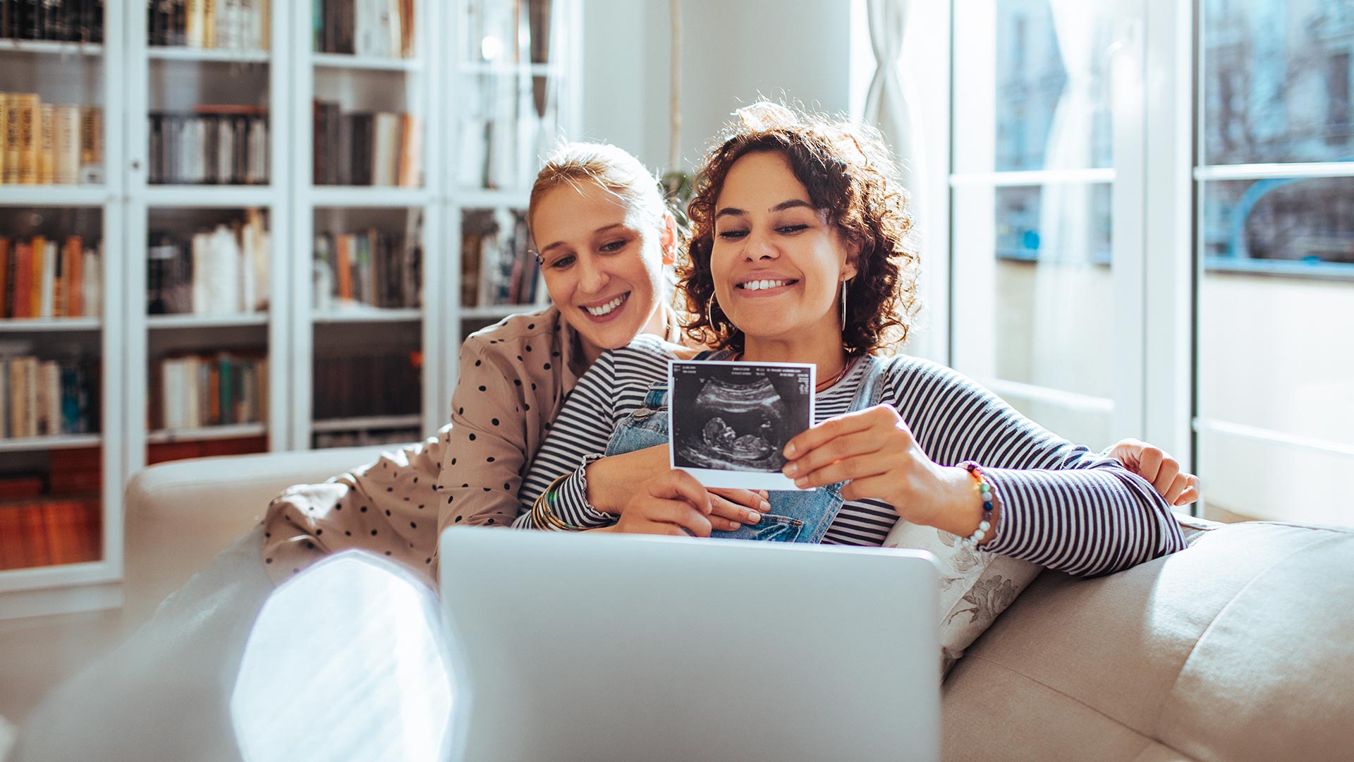 smiling people showing ultrasound image