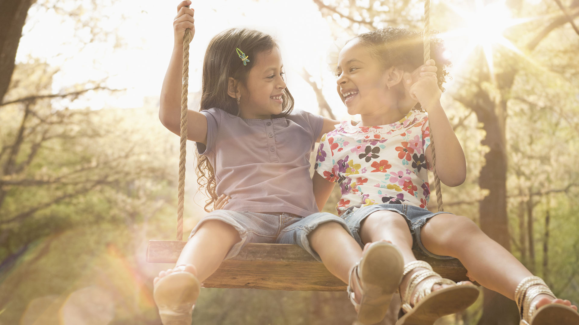 laughing children playing on the swings